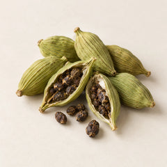 Green cardamom pods and seeds representing the cardamom fragrance note
