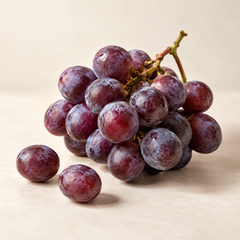 Representative a small bunch of ripe purple grapes with natural powdery bloom, two loose grapes imagery for fragrance-note discovery