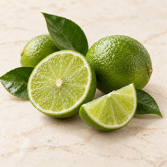 Illustration of whole and sliced green limes representing the lime fragrance note
