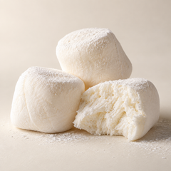 Representative three soft pale ivory marshmallow pillows with fine starch dust and a gently torn airy interior imagery for fragrance-note discovery